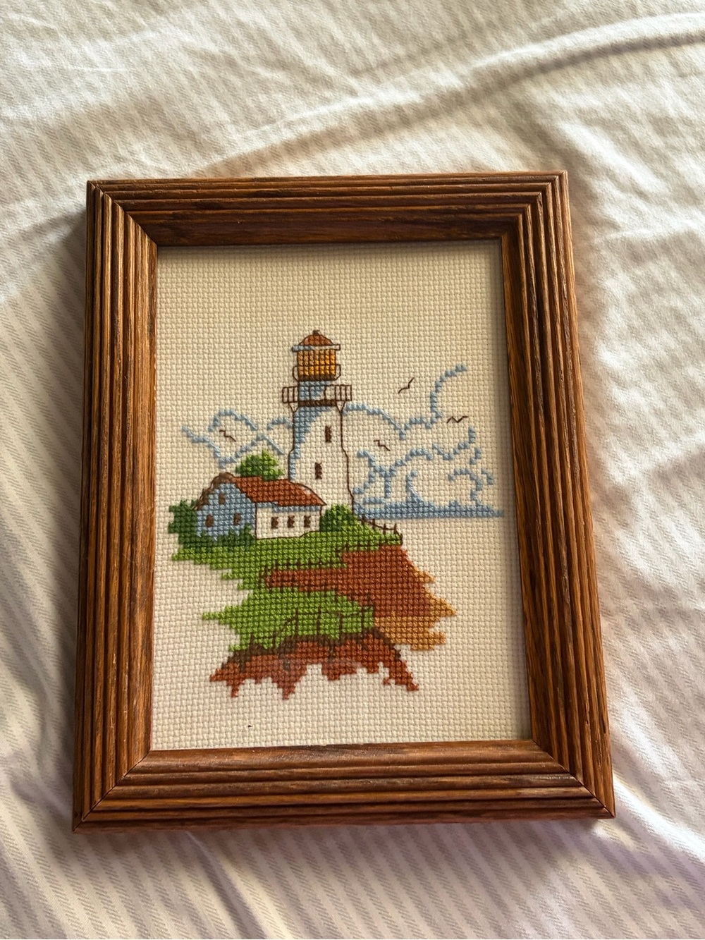 Framed Cross Stitch Lighthouse Artwork in Brown Frame
